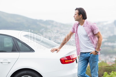 Man standing next to his car