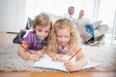 Children drawing on papers at home