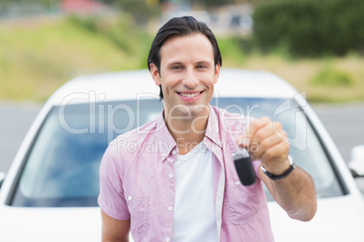 Man smiling and showing key