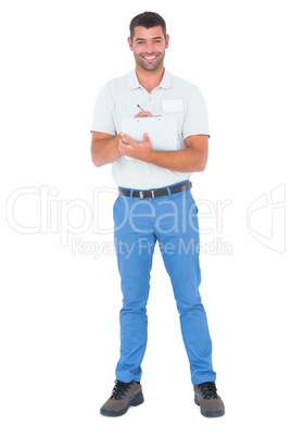 Confident male supervisor writing on clipboard over white backgr