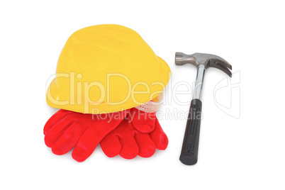 Yellow hardhat with protective gloves and hammer