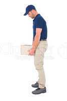 Delivery man carrying heavy package on white background