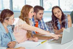 Fashion students looking at laptop