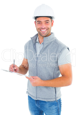 Portrait of smiling supervisor writing on clipboard