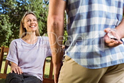 Man surprising his girlfriend with a proposal in the park