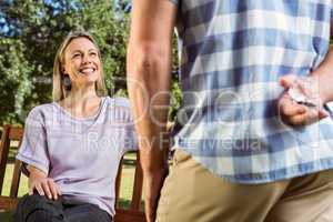 Man surprising his girlfriend with a proposal in the park