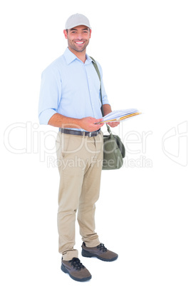 Full length portrait of happy postman with letters