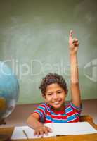 Little boy raising hand in classroom