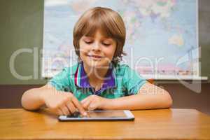 Little boy using digital tablet in classroom