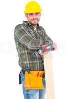 Carpenter holding power drill and wood plank