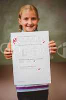 Portrait of cute little girl holding paper