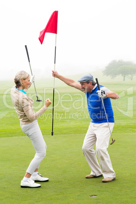 Cheering golfing couple