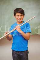 Boy playing flute in classroom