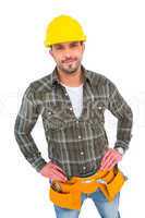 Handyman wearing tool belt with hands on hips