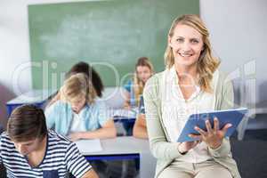 Female teacher using digital tablet in class