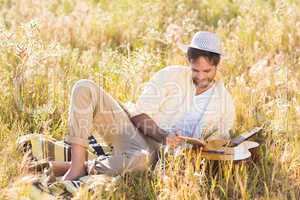 Happy man reading a book