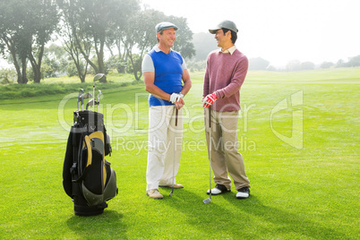Golfing friends holding clubs