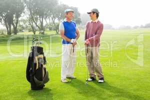 Golfing friends holding clubs