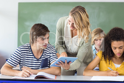 Teacher helping student in class