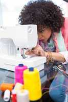 Fashion designer using sewing machine