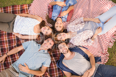 Happy friends in the park having picnic