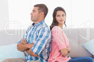 Woman looking at man while sitting on sofa