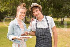 Happy friends in the park having barbecue