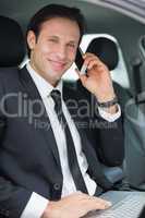 Businessman working in the drivers seat