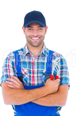 Happy repairman holding pliers on white background