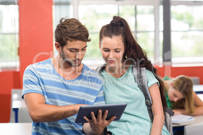 Students using digital tablet in classroom