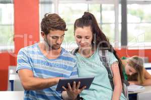 Students using digital tablet in classroom