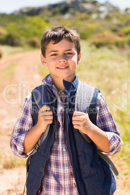 Little boy hiking in the mountains