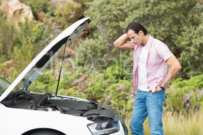 Stressed man looking at engine