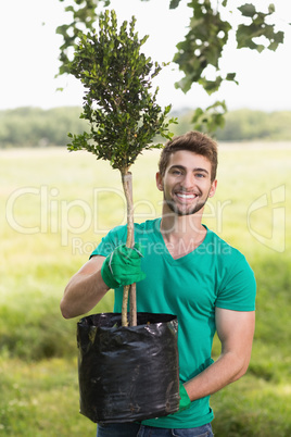 Happy young man gardening for the community