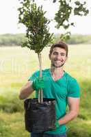Happy young man gardening for the community