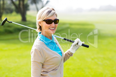 Cheerful golfer smiling at camera