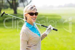 Cheerful golfer smiling at camera