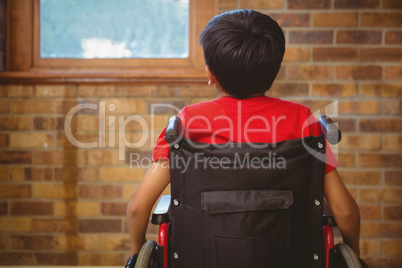 Rear view of boy sitting in wheelchair