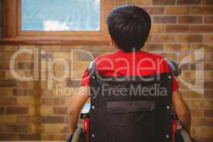 Rear view of boy sitting in wheelchair