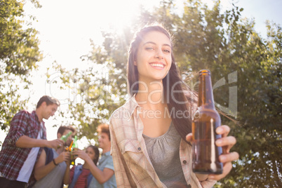 Happy friends in the park having beers