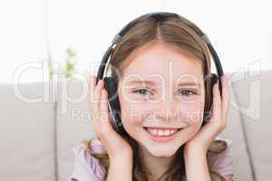 Happy girl listening music through headphones