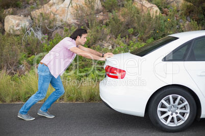 Man pushing car after a car breakdown