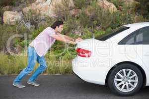 Man pushing car after a car breakdown