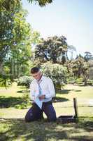 Businessman holding papers in the park