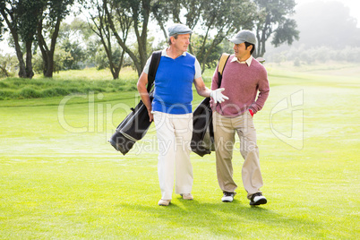 Golfer friends walking and chatting