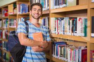 Student smiling at camera in library