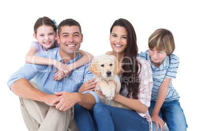 Happy family with cute dog over white background