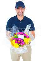 Happy delivery man holding bouquet