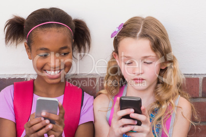 Cute pupils using mobile phone