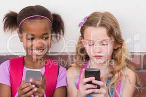Cute pupils using mobile phone